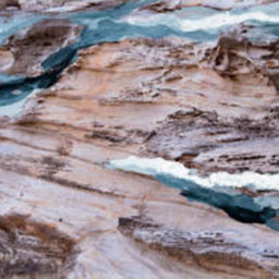 photograph of seaside rocks with water foam effect painted on top.