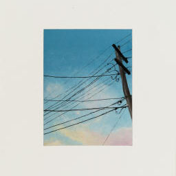 utility poll, power lines attached, cloudy blue sky.