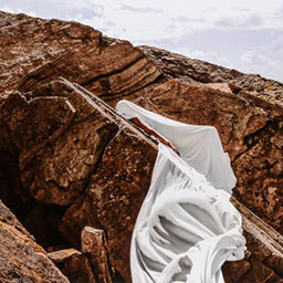 large rocky surface, jagged edges, white sheet draped over.