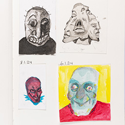 Close up of visual arts diary displaying progress images for a body of work