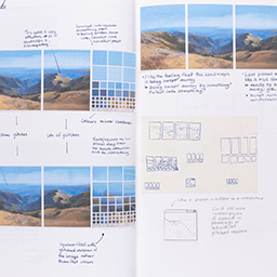 Close up of visual arts diary displaying progress images for a body of work