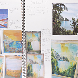 Close up of visual arts diary displaying progress images for a body of work