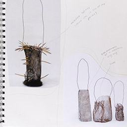 Close up of visual arts diary displaying progress images for a body of work