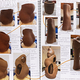 Close up of visual arts diary displaying progress images for a body of work